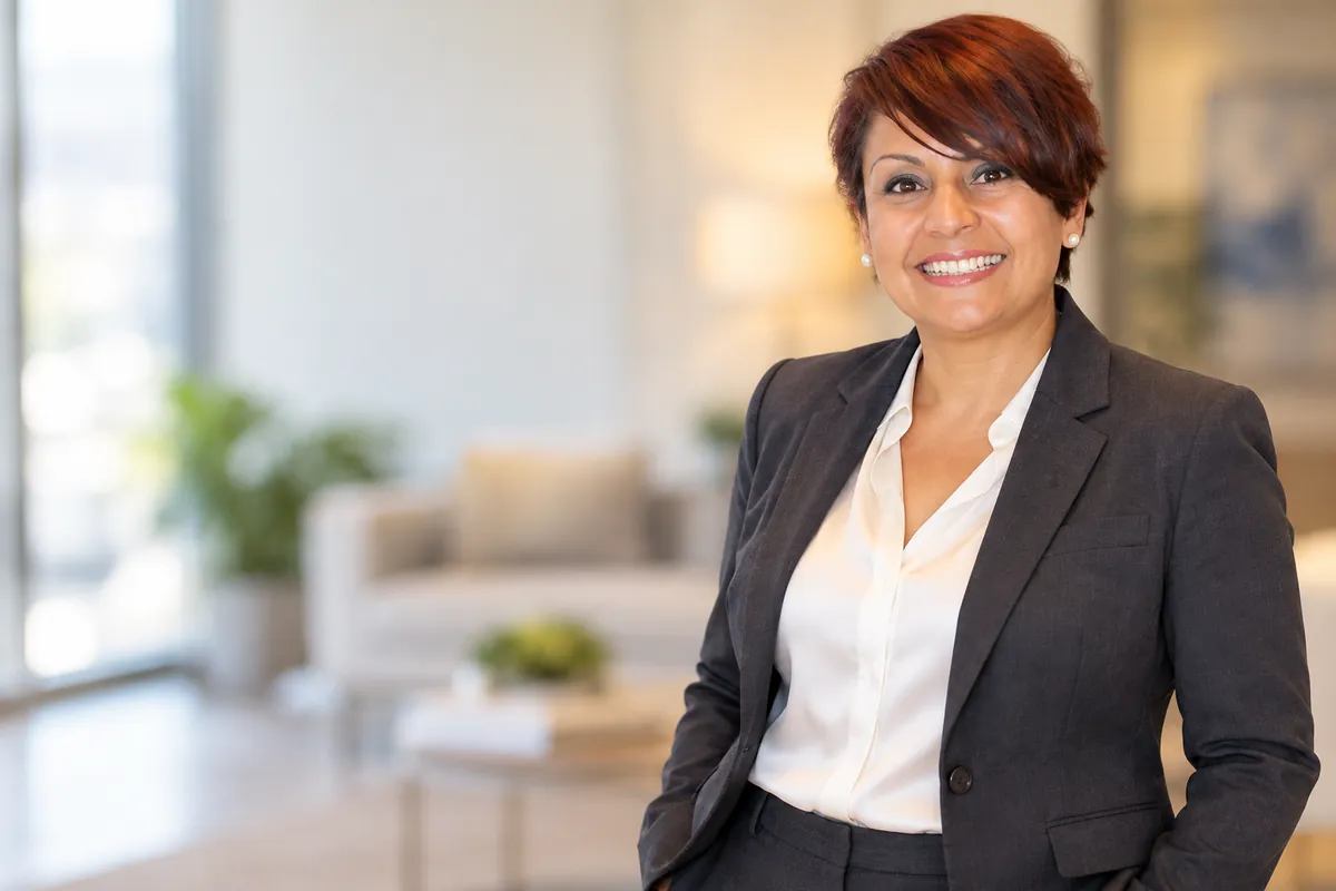 Michelle J. Lambert, CPA, smiling in a charcoal suit in her office